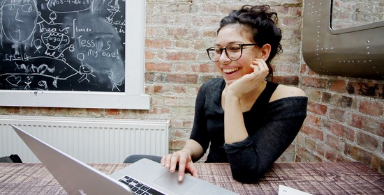 women smiling at laptop